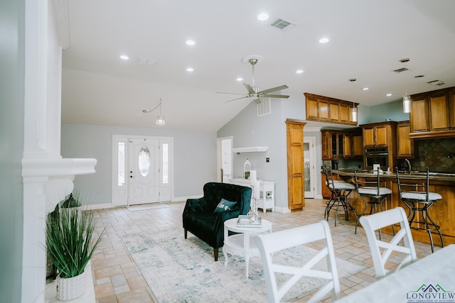 living room with ceiling fan and vaulted ceiling