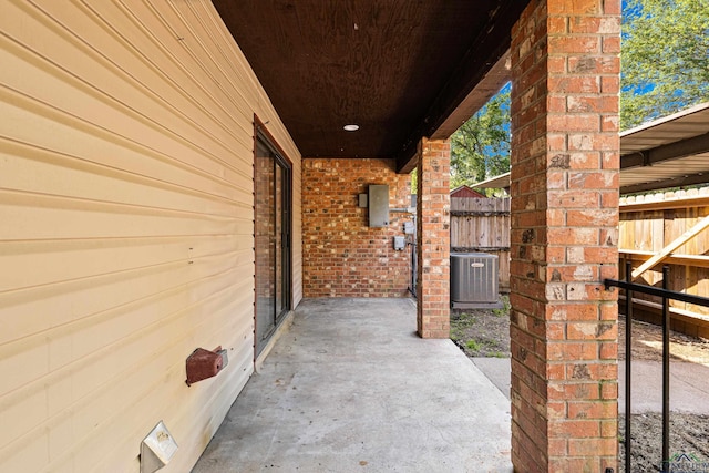 view of patio featuring central AC unit and fence