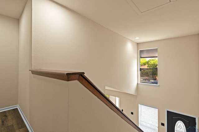 stairway with baseboards and wood finished floors