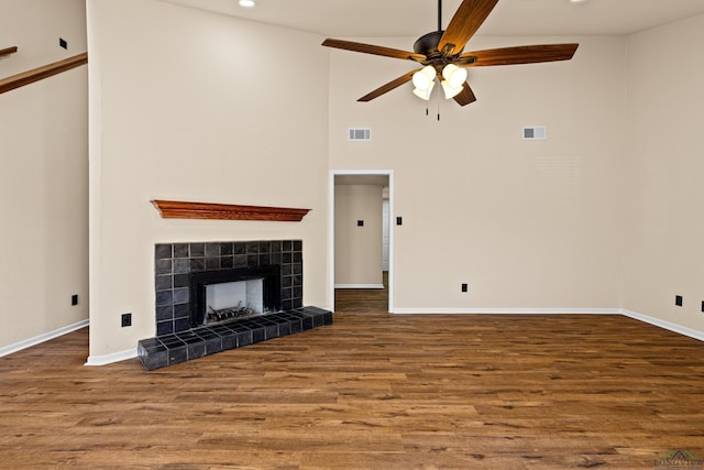 unfurnished living room with visible vents, wood finished floors, and ceiling fan