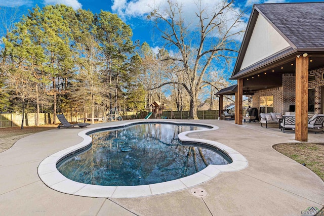 view of swimming pool featuring a playground, outdoor lounge area, and a patio area