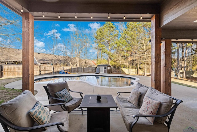 view of patio / terrace featuring a storage unit and a fenced in pool