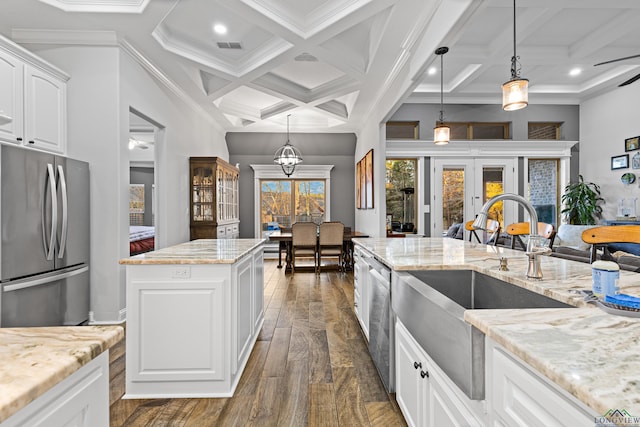 kitchen with french doors, stainless steel appliances, a center island, sink, and white cabinets