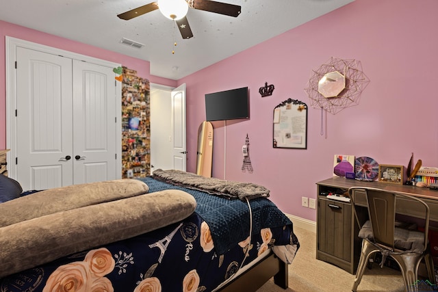 bedroom featuring a closet, ceiling fan, and light colored carpet