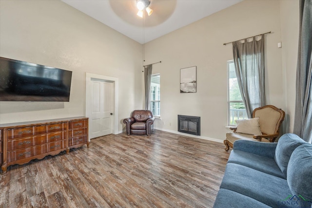 280 S Stonewall St, Tatum, TX 75691 - living area featuring wood finished floors, a ceiling fan, plenty of natural light, baseboards, and a towering ceiling