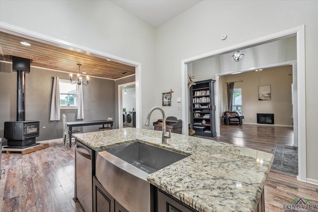 280 S Stonewall St, Tatum, TX 75691 - kitchen featuring a sink, washer and dryer, wood finished floors, plenty of natural light, and wooden ceiling