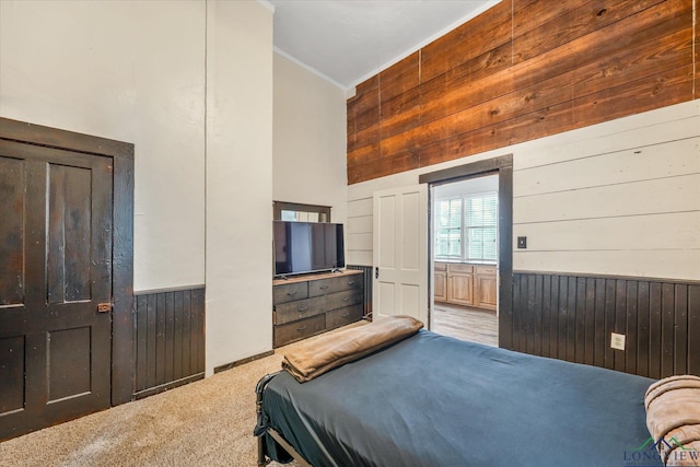 280 S Stonewall St, Tatum, TX 75691 - carpeted bedroom featuring wooden walls, ornamental molding, and a wainscoted wall