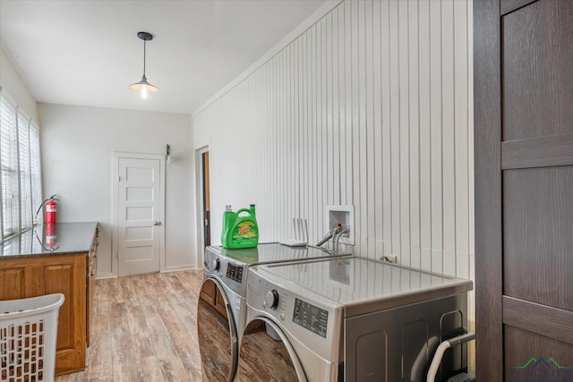280 S Stonewall St, Tatum, TX 75691 - laundry room with washer and dryer, light wood-type flooring, and cabinet space
