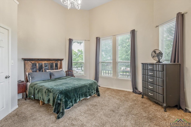280 S Stonewall St, Tatum, TX 75691 - bedroom with carpet flooring, a chandelier, a high ceiling, and baseboards