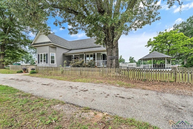 280 S Stonewall St, Tatum, TX 75691 - view of front of property with a gazebo, covered porch, roof with shingles, and a fenced front yard