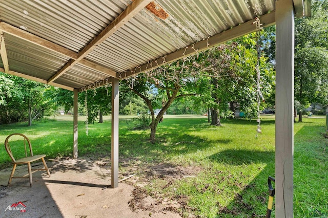 711 Comer St, Carthage, TX 75633 - view of green lawn with a patio area and view of scattered trees
