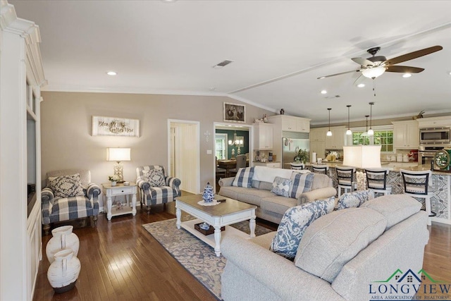 living room with crown molding, lofted ceiling, dark wood-type flooring, and ceiling fan