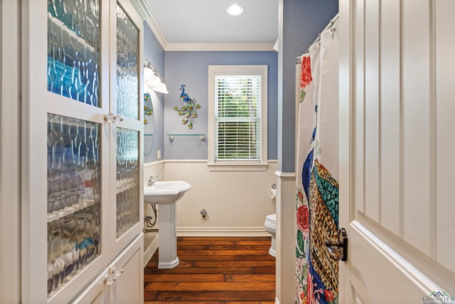 bathroom featuring hardwood / wood-style flooring, toilet, and ornamental molding