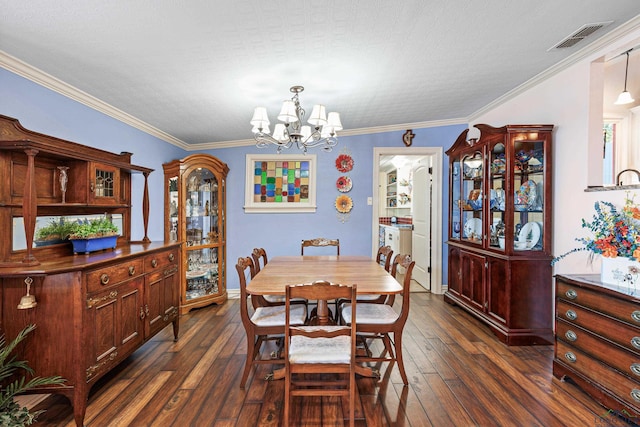 dining space featuring ornamental molding, dark wood-type flooring, and a notable chandelier