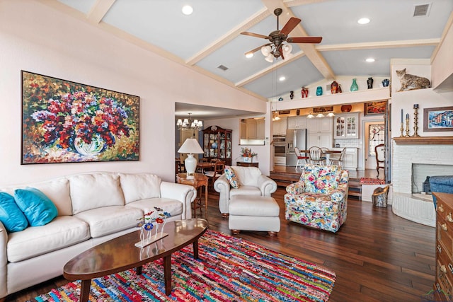 living room featuring a fireplace, ceiling fan with notable chandelier, lofted ceiling with beams, and dark wood-type flooring