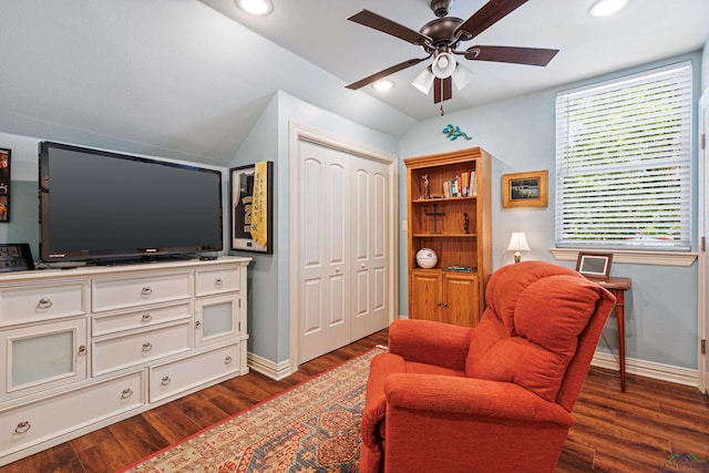 living area with dark hardwood / wood-style floors, ceiling fan, and lofted ceiling