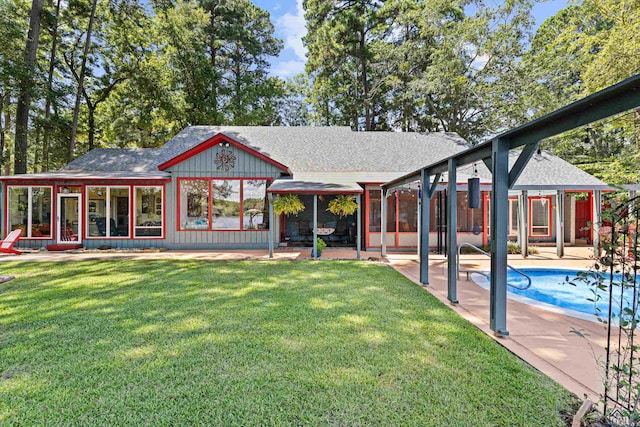 back of property with a yard and a patio area