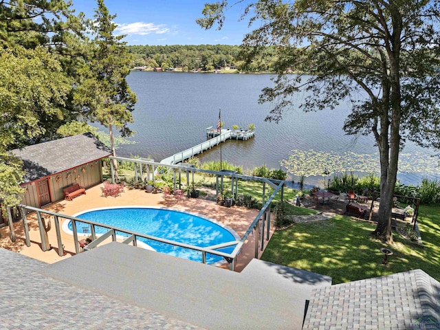 view of swimming pool featuring a yard, a patio area, a dock, and a water view