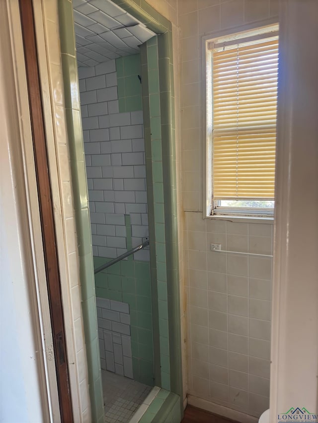 bathroom with a tile shower