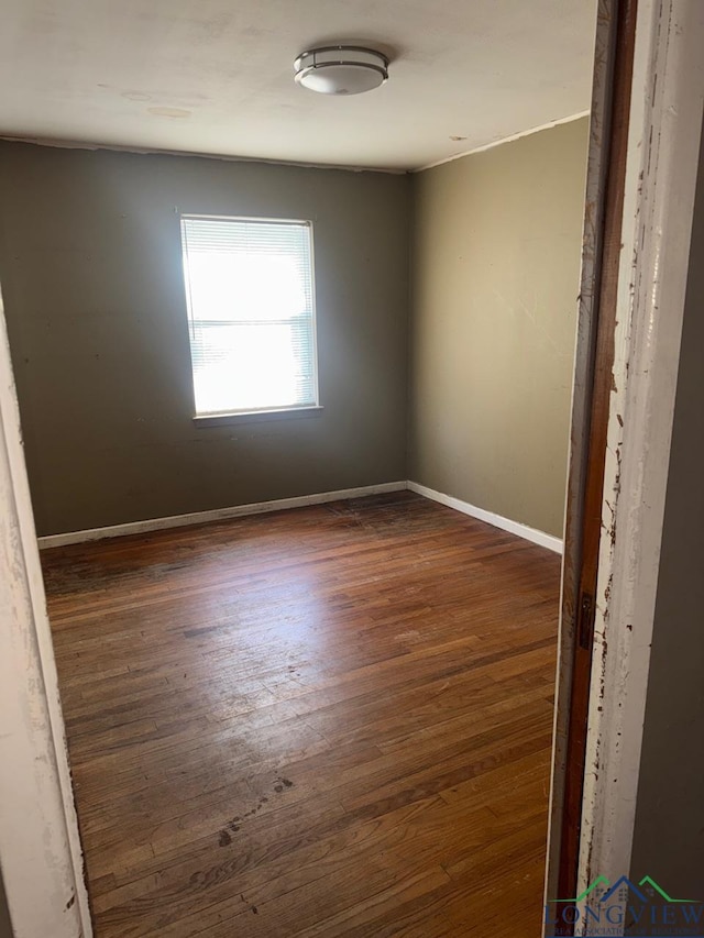 spare room featuring dark hardwood / wood-style floors