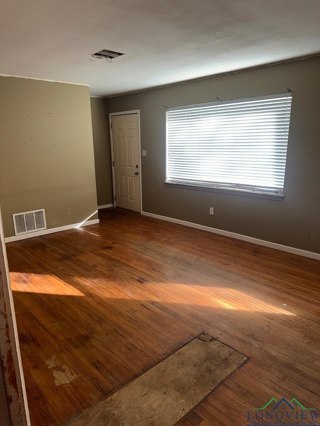 empty room featuring wood-type flooring