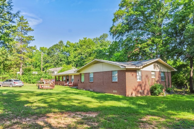 view of property exterior with a lawn