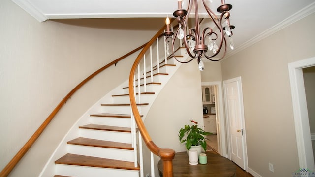 stairs featuring crown molding and an inviting chandelier