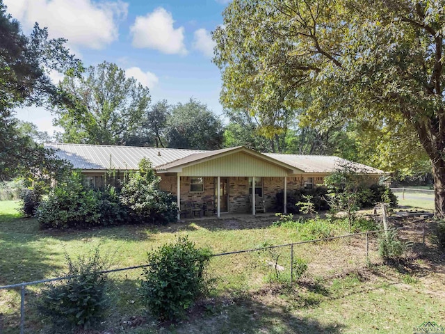 ranch-style home with a front lawn