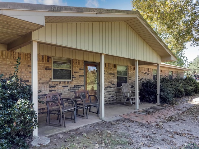 back of property with a porch