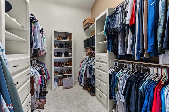 walk in closet featuring light carpet