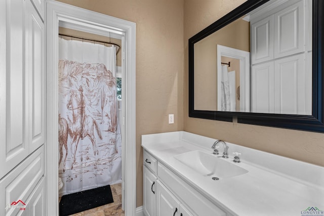 bathroom featuring walk in shower, vanity, and toilet