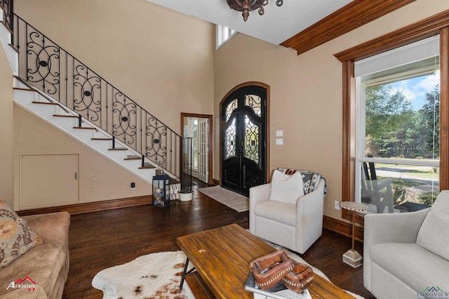 living room with plenty of natural light, dark wood-type flooring, and french doors