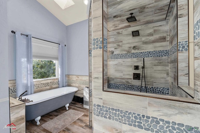 bathroom with hardwood / wood-style floors, shower with separate bathtub, lofted ceiling with skylight, and tile walls