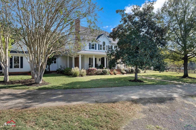 view of front of home featuring a front yard and a porch