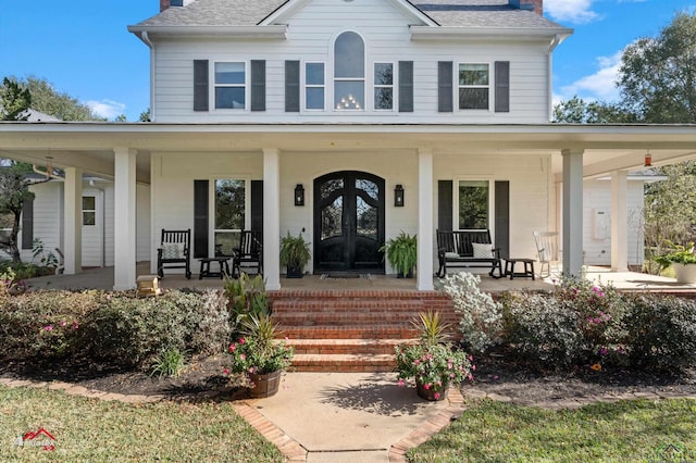 view of front of house featuring covered porch and french doors