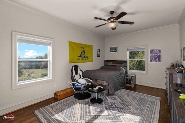 bedroom with ceiling fan, dark hardwood / wood-style flooring, and crown molding