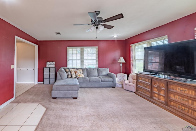 carpeted living room with ceiling fan