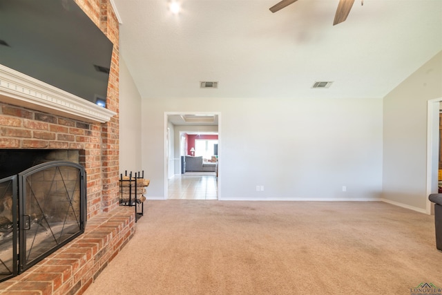 living room with a fireplace, carpet flooring, and ceiling fan