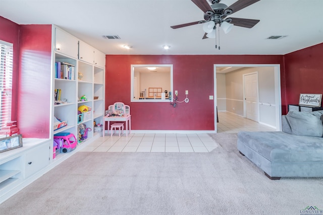 recreation room with light carpet and ceiling fan