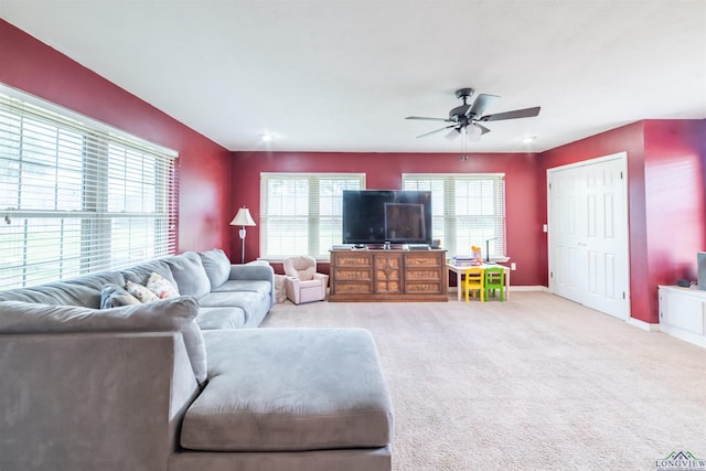 carpeted living room featuring ceiling fan