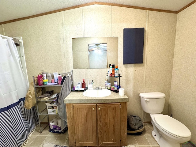 bathroom with vanity, toilet, crown molding, and vaulted ceiling