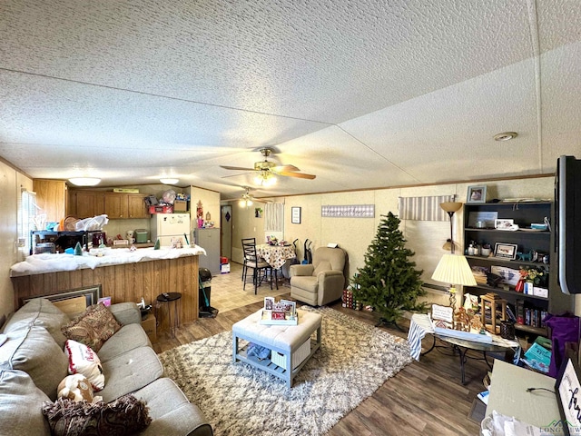 living room featuring wood-type flooring and ceiling fan