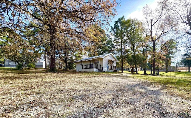 view of side of property with covered porch