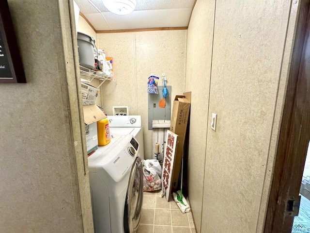 washroom with washer and clothes dryer, light tile patterned flooring, and ornamental molding