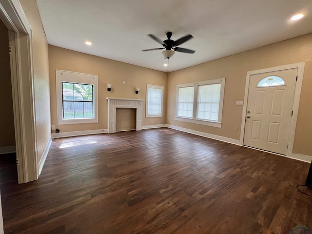 1411 E Timpson St, Longview, TX 75601 - unfurnished living room featuring ceiling fan, dark wood finished floors, baseboards, a fireplace, and recessed lighting