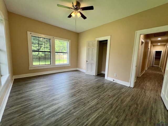 1411 E Timpson St, Longview, TX 75601 - unfurnished room with dark wood-style flooring, a ceiling fan, and baseboards