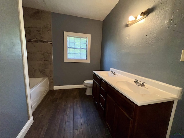 1411 E Timpson St, Longview, TX 75601 - full bath with hardwood / wood-style floors, toilet, double vanity, and baseboards