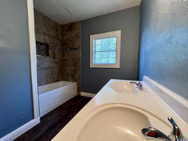 1411 E Timpson St, Longview, TX 75601 - full bath with wood finished floors, baseboards, and double vanity