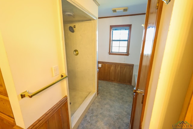 bathroom featuring a shower and ornamental molding