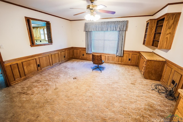 interior space with light carpet, a healthy amount of sunlight, ceiling fan, and ornamental molding